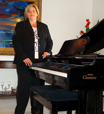 Kathy and her piano look forward to teaching your child to play.